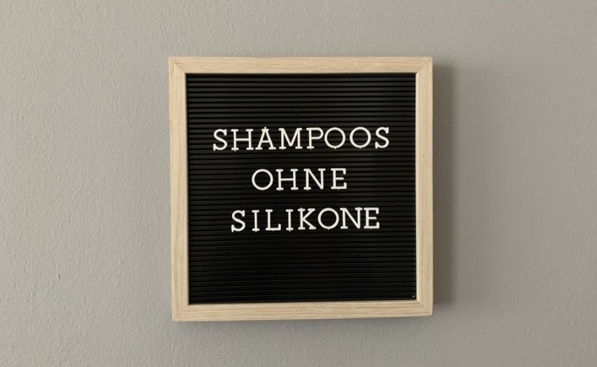 Schwarze Tafel, auf der "Shampoo ohne Silikone" steht